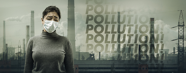 Image showing Caucasian woman wearing the respiratory protection mask against air pollution and dusk with factories on background