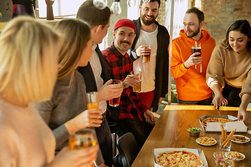 Image showing Happy co-workers celebrating while company party and corporate event