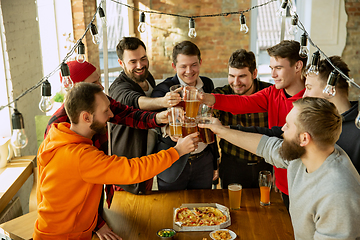 Image showing Happy co-workers celebrating while company party and corporate event