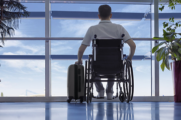 Image showing Young man in a wheelchair at the airport 