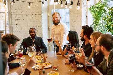 Image showing Happy co-workers celebrating while company party and corporate event