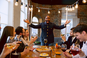 Image showing Happy co-workers celebrating while company party and corporate event