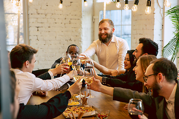 Image showing Happy co-workers celebrating while company party and corporate event