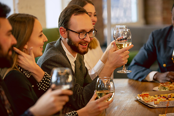 Image showing Happy co-workers celebrating while company party and corporate event