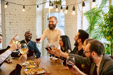 Image showing Happy co-workers celebrating while company party and corporate event