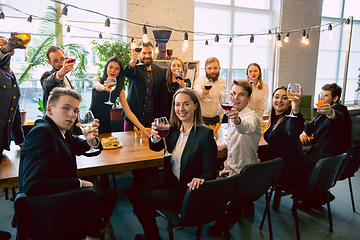 Image showing Happy co-workers celebrating while company party and corporate event