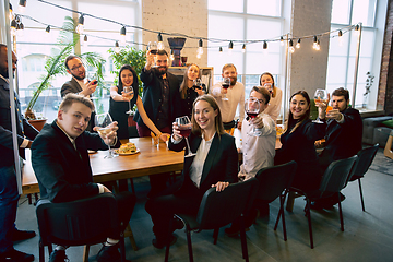 Image showing Happy co-workers celebrating while company party and corporate event