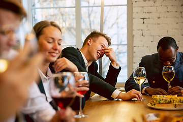 Image showing Happy co-workers celebrating while company party and corporate event