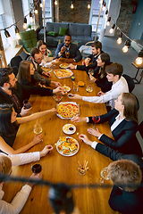 Image showing Happy co-workers celebrating while company party and corporate event