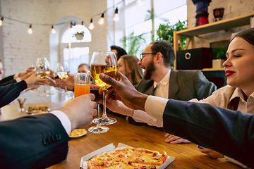 Image showing Happy co-workers celebrating while company party and corporate event