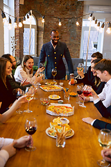 Image showing Happy co-workers celebrating while company party and corporate event