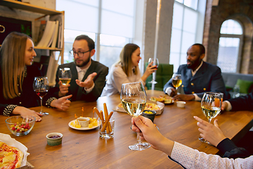 Image showing Happy co-workers celebrating while company party and corporate event