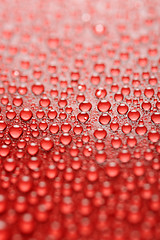 Image showing water drops on red background