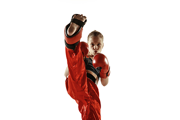 Image showing Young female kickboxing fighter training isolated on white background