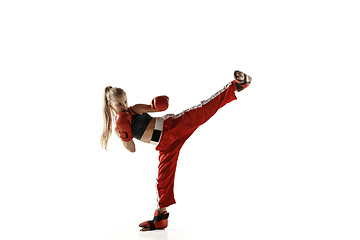 Image showing Young female kickboxing fighter training isolated on white background