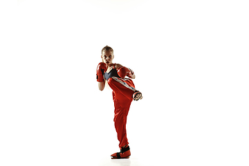 Image showing Young female kickboxing fighter training isolated on white background