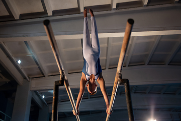 Image showing Little male gymnast training in gym, flexible and active