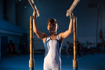 Image showing Little male gymnast training in gym, flexible and active