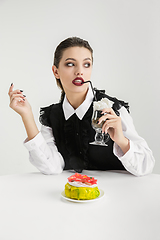 Image showing We are what we eat. Woman\'s eating plastic food, eco concept