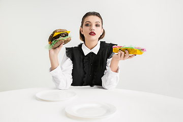 Image showing We are what we eat. Woman\'s eating plastic food, eco concept