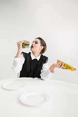 Image showing We are what we eat. Woman\'s eating plastic food, eco concept