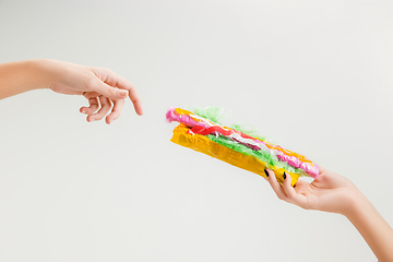 Image showing We are what we eat. Close up of female hand with plastic food, eco concept