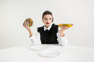 Image showing We are what we eat. Woman\'s eating plastic food, eco concept