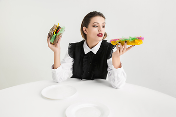 Image showing We are what we eat. Woman\'s eating plastic food, eco concept