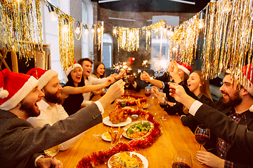 Image showing Happy co-workers celebrating while company party for New Year and Christmas