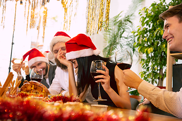 Image showing Happy co-workers celebrating while company party for New Year and Christmas