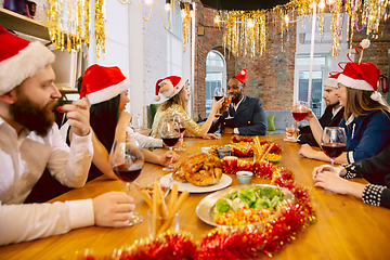 Image showing Happy co-workers celebrating while company party for New Year and Christmas