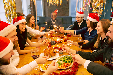 Image showing Happy co-workers celebrating while company party for New Year and Christmas