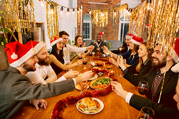 Image showing Happy co-workers celebrating while company party for New Year and Christmas