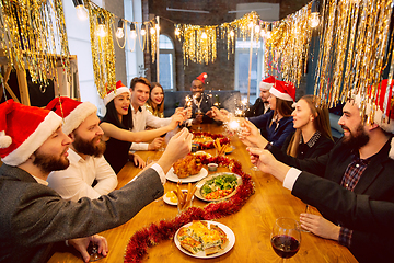 Image showing Happy co-workers celebrating while company party for New Year and Christmas