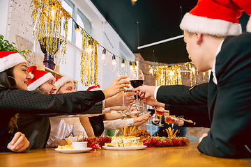 Image showing Happy co-workers celebrating while company party for New Year and Christmas