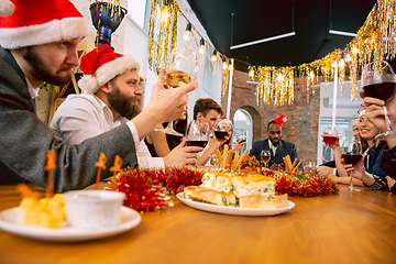 Image showing Happy co-workers celebrating while company party for New Year and Christmas