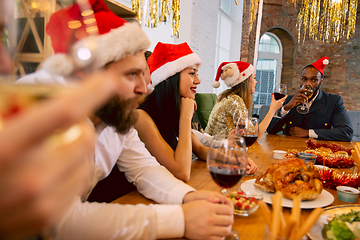 Image showing Happy co-workers celebrating while company party for New Year and Christmas