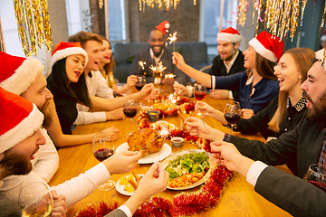 Image showing Happy co-workers celebrating while company party for New Year and Christmas