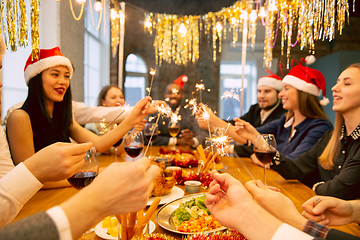 Image showing Happy co-workers celebrating while company party for New Year and Christmas