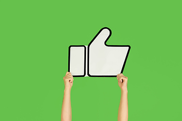 Image showing Hands holding the sign of like on green studio background