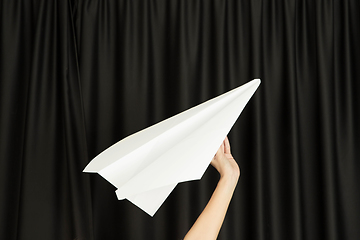 Image showing Hands holding the sign of paper airplane on studio background