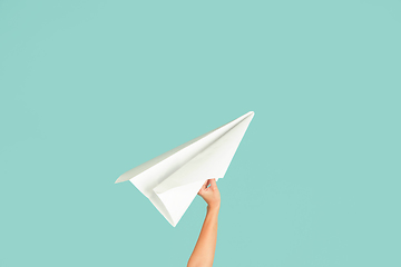 Image showing Hands holding the sign of paper airplane on studio background