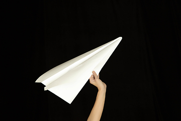 Image showing Hands holding the sign of paper airplane on studio background