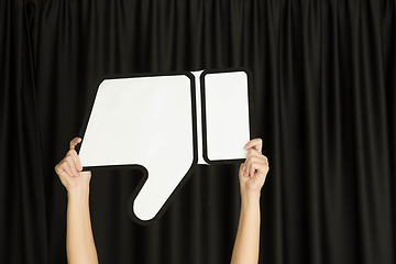 Image showing Hands holding the sign of dislike on black studio background