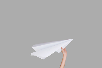 Image showing Hands holding the sign of paper airplane on studio background