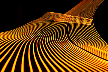 Image showing Bright neon line designed background, shot with long exposure, yellow gold