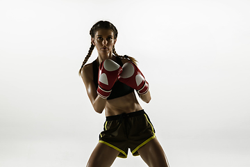 Image showing Fit caucasian woman in sportswear boxing isolated on white studio background