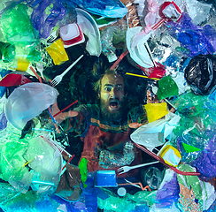 Image showing Man drowning in ocean water under plastic recipients pile, environment concept