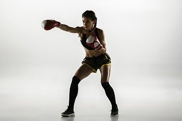 Image showing Fit caucasian woman in sportswear boxing isolated on white studio background