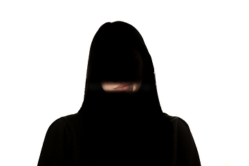 Image showing Dramatic portrait of a girl in the dark on white studio background.